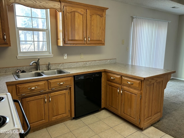 kitchen featuring dishwasher, sink, stove, light colored carpet, and kitchen peninsula