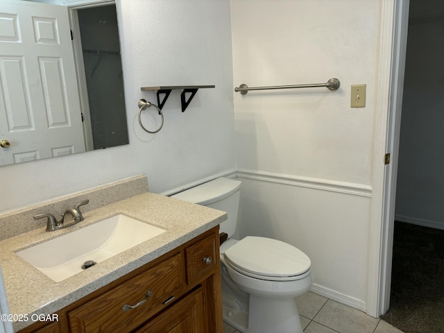 bathroom featuring vanity, tile patterned floors, and toilet