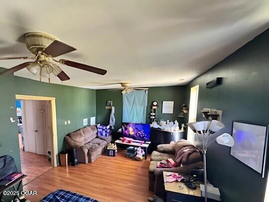 living room with a ceiling fan and wood finished floors