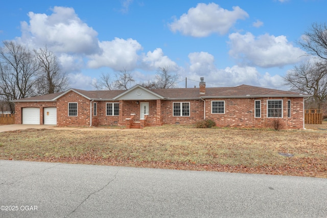 ranch-style home featuring a garage and a front lawn