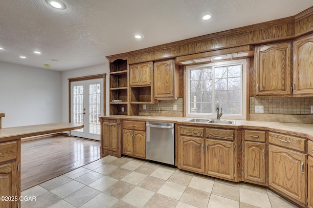 kitchen with french doors, sink, a textured ceiling, dishwasher, and backsplash