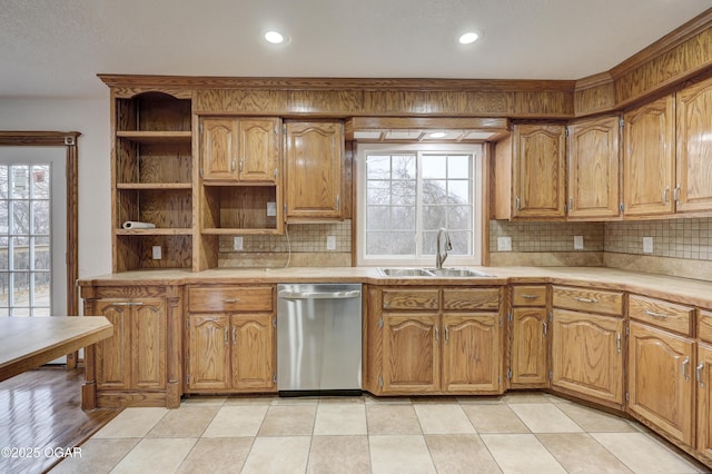 kitchen with tasteful backsplash, dishwasher, and sink