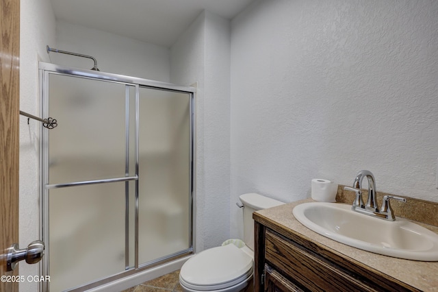 bathroom with vanity, toilet, and walk in shower