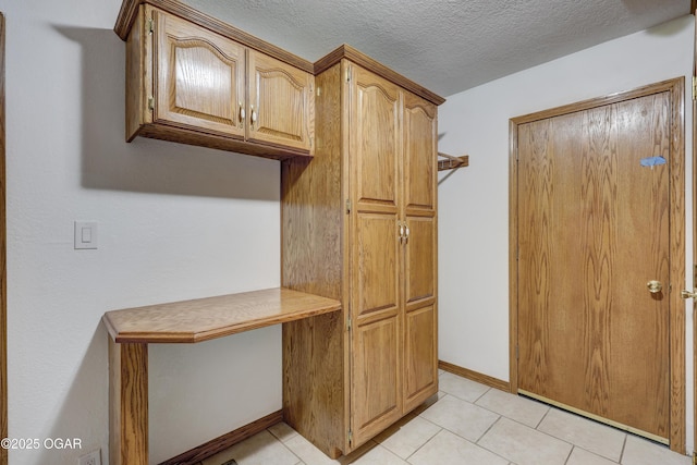 kitchen with light tile patterned floors and a textured ceiling