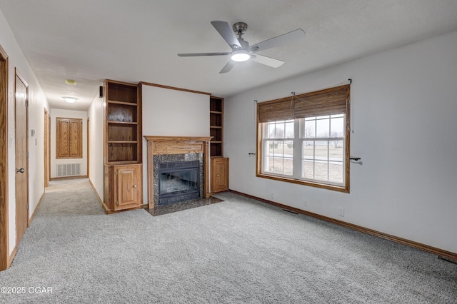 unfurnished living room with ceiling fan and light colored carpet