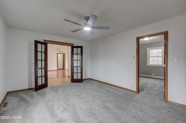 empty room with light carpet, ceiling fan, and french doors