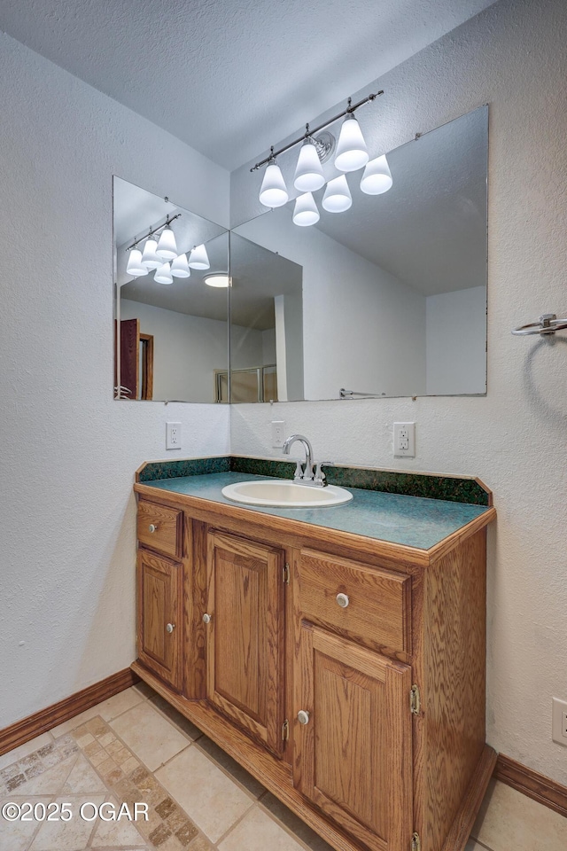 bathroom with vanity, tile patterned flooring, and a textured ceiling