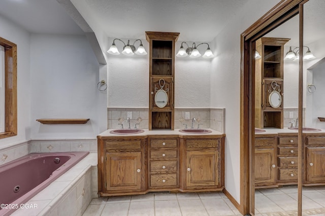 bathroom with tasteful backsplash, tile patterned floors, vanity, and tiled tub