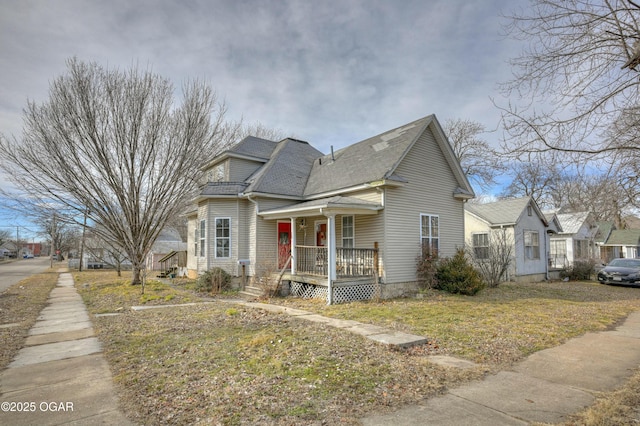 view of front of house with a porch and a front yard