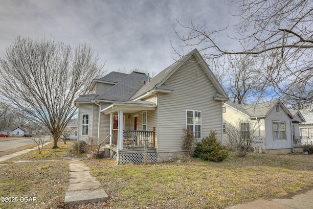 view of front of property with covered porch and a front yard