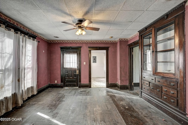 interior space with dark wood-type flooring and ceiling fan