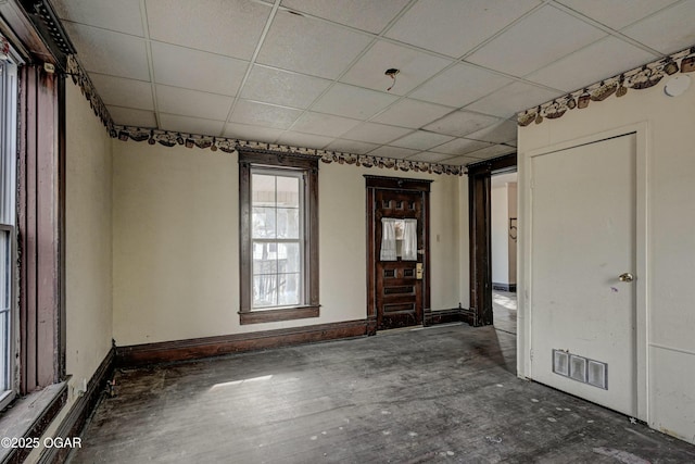 unfurnished room featuring a paneled ceiling