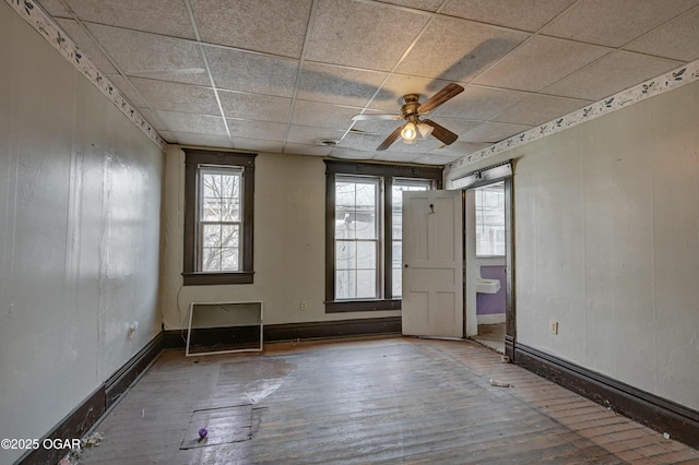 spare room featuring hardwood / wood-style floors, a paneled ceiling, and ceiling fan