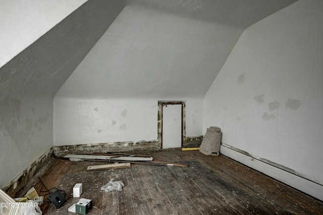 bonus room featuring lofted ceiling, hardwood / wood-style floors, and baseboard heating