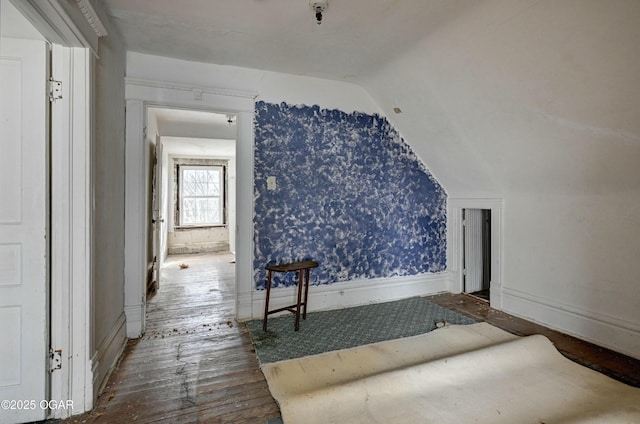 bonus room with lofted ceiling and hardwood / wood-style floors