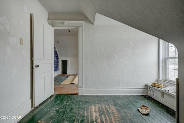 bonus room with dark hardwood / wood-style floors