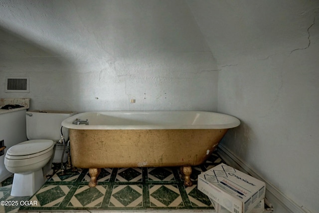 bathroom with toilet and a tub