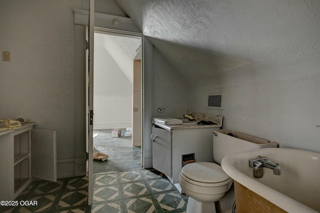 bathroom with lofted ceiling and sink