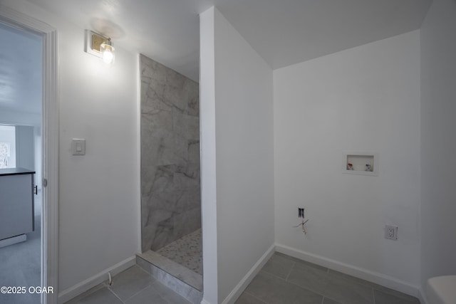 bathroom with tiled shower and tile patterned floors