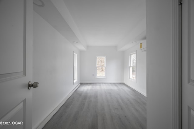 unfurnished room with a wall mounted air conditioner and light wood-type flooring