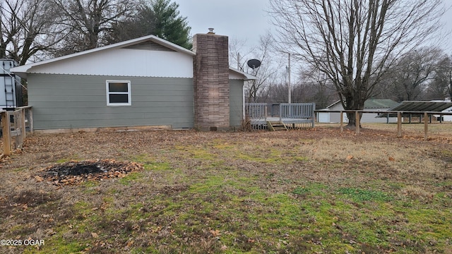 view of property exterior featuring a wooden deck