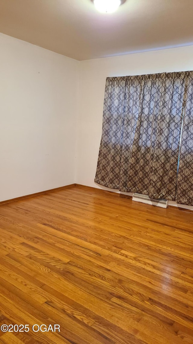 unfurnished room featuring wood-type flooring