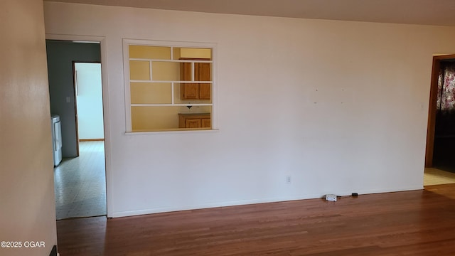 unfurnished room with hardwood / wood-style flooring