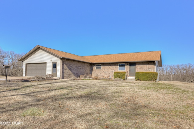 single story home featuring a garage and a front yard