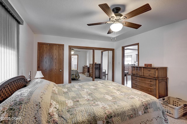 bedroom with carpet floors, two closets, and ceiling fan