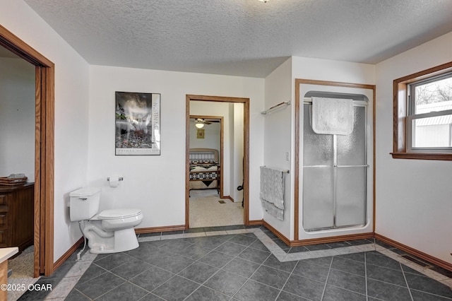 bathroom with a textured ceiling, a shower with shower door, tile patterned floors, and toilet