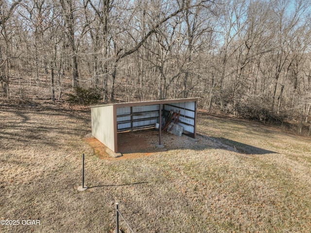 view of property's community with an outdoor structure and a lawn