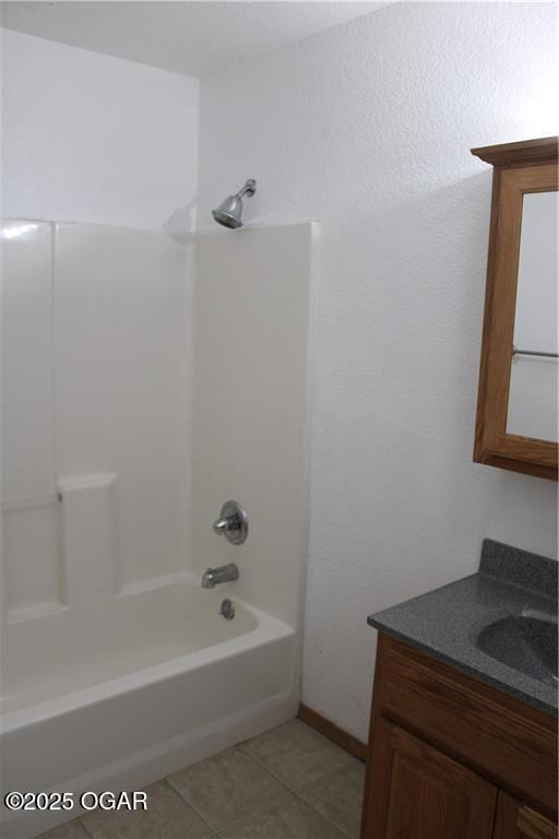 bathroom featuring  shower combination, tile patterned flooring, and vanity