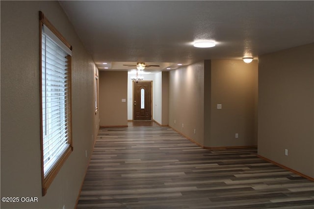 interior space with dark hardwood / wood-style floors and ceiling fan