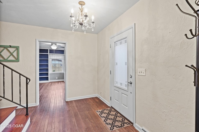 entryway featuring hardwood / wood-style floors and a notable chandelier