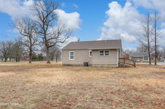 rear view of house featuring a yard and cooling unit