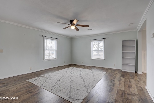 empty room featuring wood-type flooring, ornamental molding, ceiling fan, and a wealth of natural light