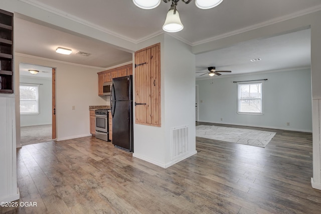 kitchen featuring dark wood-style flooring, visible vents, stainless steel appliances, and crown molding