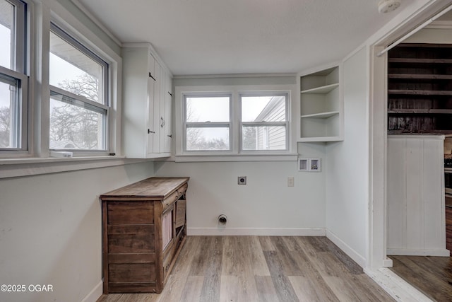 washroom with hookup for a washing machine, light wood-style floors, hookup for an electric dryer, laundry area, and baseboards