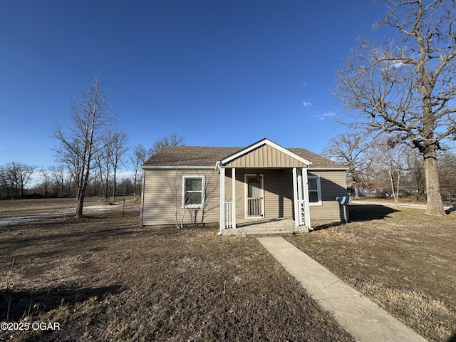 bungalow featuring a porch, board and batten siding, and a shingled roof