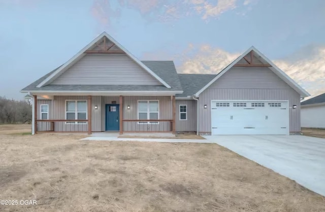 view of front of home with a garage and a porch