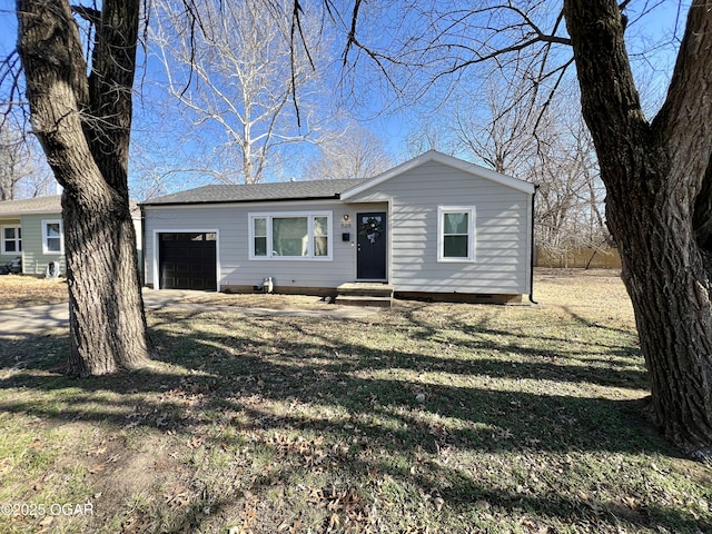 single story home with a garage and a front yard