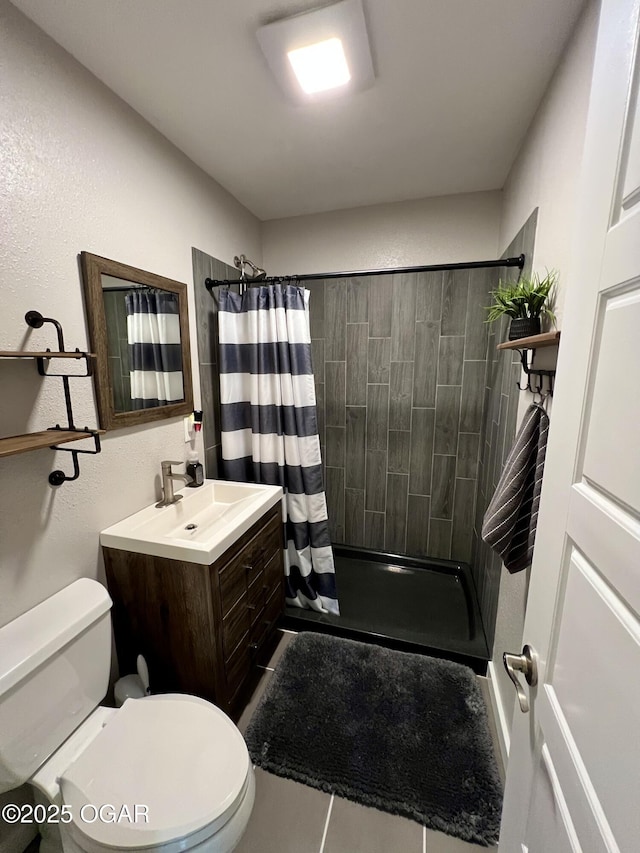 bathroom featuring vanity, toilet, and walk in shower