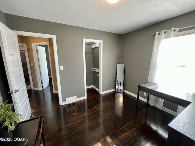 unfurnished room featuring dark wood-type flooring