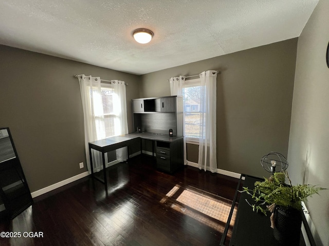 office space featuring a textured ceiling and dark hardwood / wood-style flooring