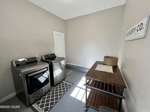 clothes washing area with separate washer and dryer