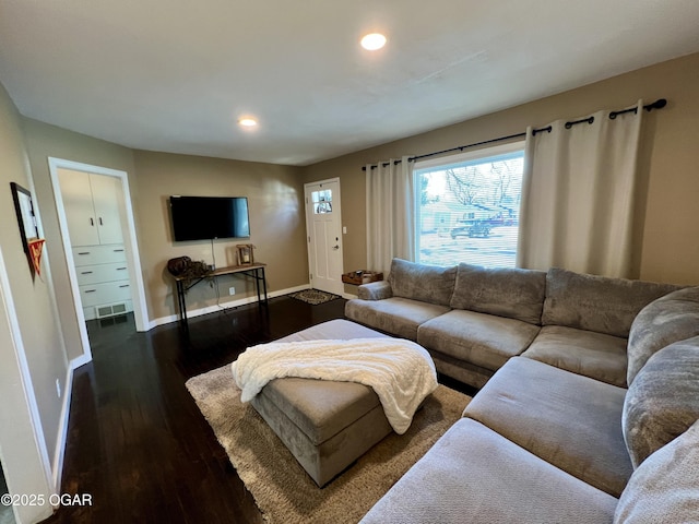 living room with dark hardwood / wood-style flooring