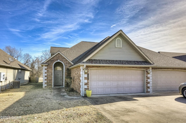 view of front of home featuring a garage and cooling unit