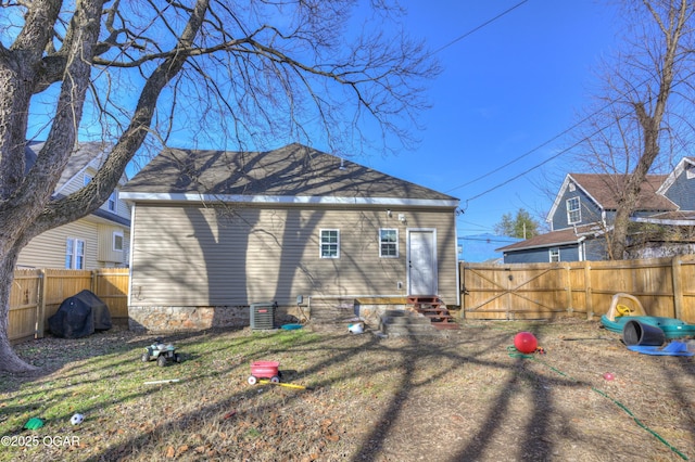 rear view of property with central AC