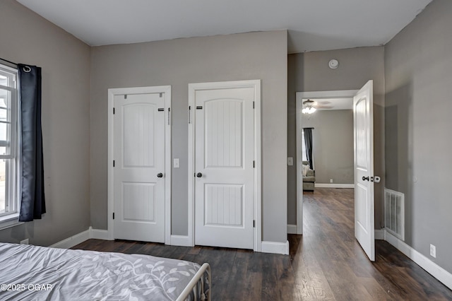 unfurnished bedroom with dark wood-type flooring