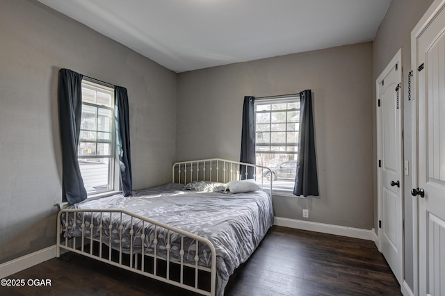 bedroom with a closet and dark hardwood / wood-style floors